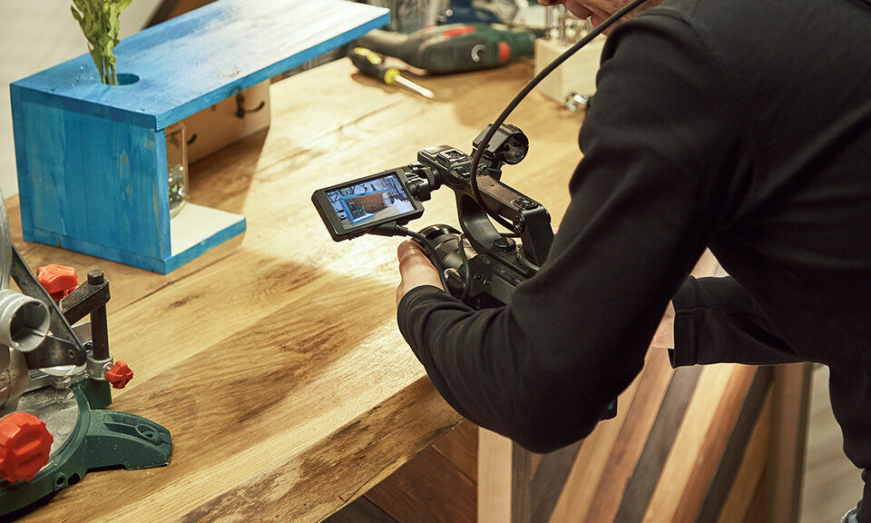 Video production backstage. Behind the scenes of creating video content, a professional team of cameramen with a director filming commercial ads. Video content creation, video creation industry.